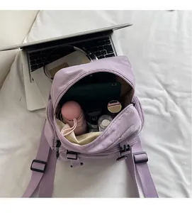 Detail of lavender canvas backpack interior showing large capacity and storage compartments