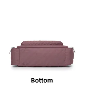 Bottom view of mauve nylon crossbody bag featuring quilted diamond pattern and smooth base