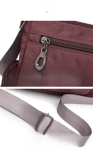 Close-up of quilted nylon crossbody bag featuring smooth zippers and adjustable strap buckle