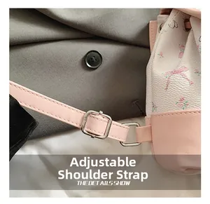 Close-up of adjustable shoulder strap with silver buckle on pink floral backpack
