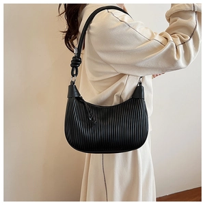 Close-up of black pleated hobo bag showing vertical texture and knot strap details