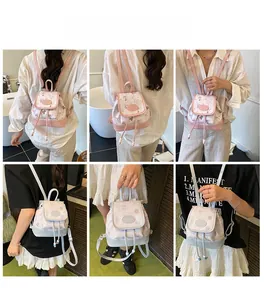 Detail of pink and light blue canvas backpacks with cute prints and drawstring closure
