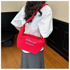 Red large capacity nylon shoulder bag with blue lettering shown from a back perspective