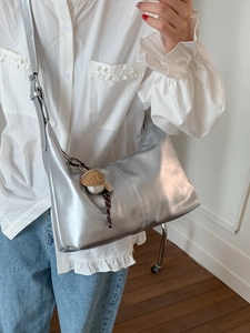 Chic silver metallic dumpling bag for women with baseball charm and wide strap