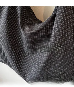 Close-up of the lightweight black and white gingham fabric texture on this tote bag