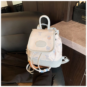 Detail of mini backpack with cute bear prints, drawstring closure, and SunnyDay logo
