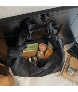 Detail view of large plaid tote bag showing ample space for tablets and umbrellas