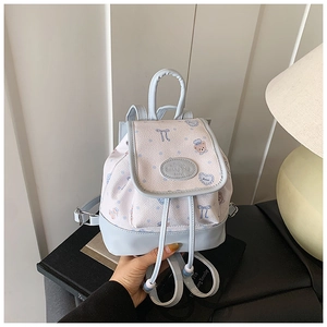 Detail of mini patchwork backpack with cartoon print and light blue leather accents