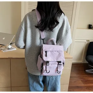 Rear view of a lavender multi-functional canvas backpack with dual buckle closure
