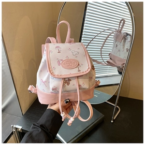 Detail of a pink and white floral mini backpack with bear and puppy patterns