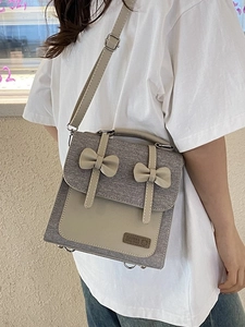 Chic grey fabric and beige leather patchwork crossbody bag with double bow detail