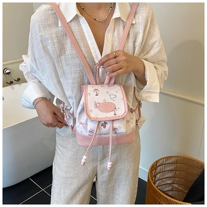 Detail of floral canvas bucket bag with pink leather trim and cartoon patterns