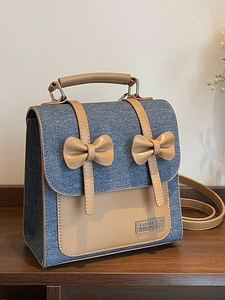 Mini denim and leather backpack with decorative bows and adjustable shoulder straps