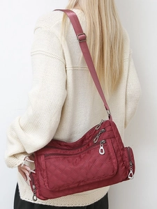 Lightweight burgundy quilted nylon crossbody bag with multi-zipper compartments for women