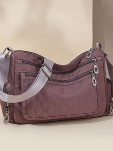 Quilted nylon crossbody bag with multiple zip pockets and adjustable strap in dark purple
