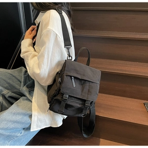 Detail view of the black nylon canvas multi-functional backpack with durable buckles