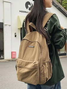 Large khaki canvas backpack for men featuring a minimalist casual style for travel and school