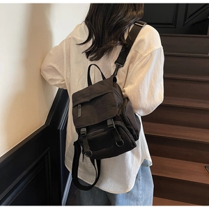 Detailed view of black waterproof nylon backpack with adjustable straps and multi-pockets