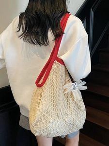 Large summer mesh tote bag with red knit strap and decorative floral pendant