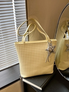 Chic yellow woven bucket bag with star and tassel charms for women's daily commute