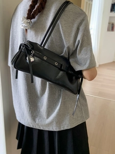 Chic black patent leather shoulder bag with silver eyelets and heart charm detail
