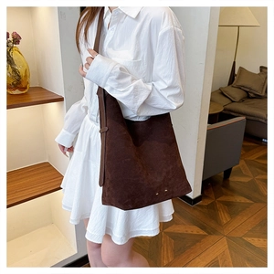 Close-up of vintage brown suede hobo bag with large capacity for office commuting