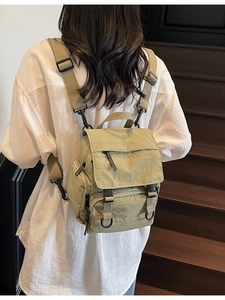 Green versatile canvas backpack with adjustable straps and multi-pocket functional design