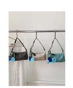 Detailed trio of woven crossbody bags in grey, beige, and green with cute elephant charms