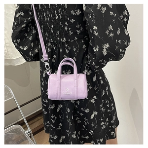 Close-up of a lilac mini pillow bag showing the litchi texture and detachable strap