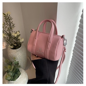 Detail of pink mini Boston bag in pebble leather with silver hardware and logo