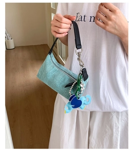 Light blue knitted handbag featuring a pleated wavy texture and cute elephant charm