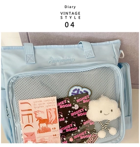 Macro view of light blue nylon tote bag with transparent mesh pocket and embroidery