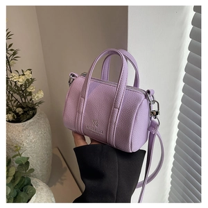 Detail of lavender litchi leather mini Boston bag with silver zipper and logo