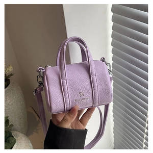 Detail of lavender litchi grain leather mini pillow bag with silver star logo hardware