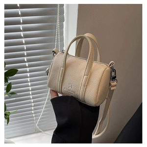 Detail view of mini pillow bag with litchi texture and detachable crossbody strap