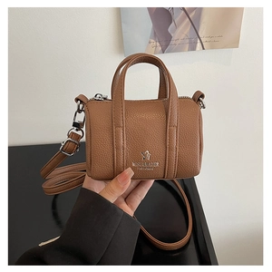 Detailed macro view of the brown lychee grain leather mini Boston bag with silver hardware