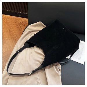 Detail of minimalist black matte tote bag with iconic white four-corner stitching design