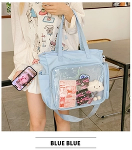 Detail of light blue ita bag showing the clear display pocket with cute decorations