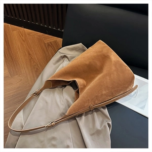 Detailed texture of brown suede tote bag featuring slim straps and a minimalist look