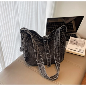 Close-up of acid wash denim tote bag showing vintage texture and silver metal eyelets