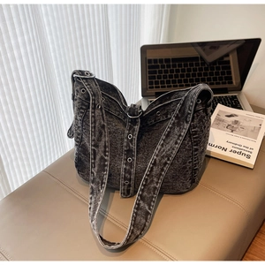Close-up of dark grey washed denim tote bag with metal eyelet details and retro style
