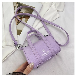 Close-up of lilac lychee grain leather mini pillow bag with silver metal logo detail