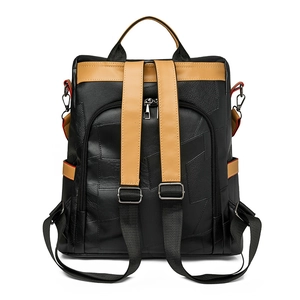 Detail view of the backpack back with adjustable brown straps and black faux leather texture