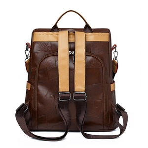 Detail view of large capacity patchwork backpack with brown and beige leather panels