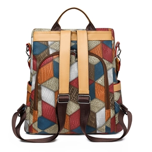 Detail of multi-textured patchwork leather backpack with crocodile and litchi patterns