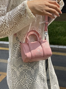 Pink lychee texture leather mini barrel bag with silver hardware and adjustable strap