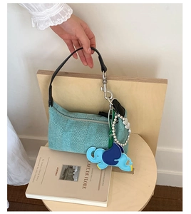 Detail of light blue canvas tote with cute elephant charm and pearl bead accents
