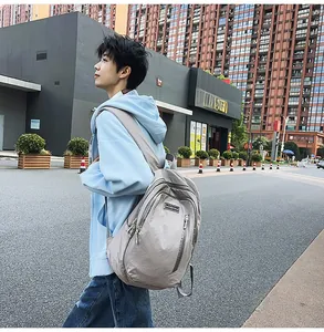 Side view of large light grey nylon backpack with multi-functional compartments