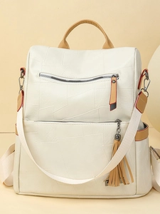 Stylish cream travel backpack with textured patchwork, leather tassels, and large capacity