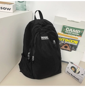 Detailed close-up of a minimalist black waterproof nylon backpack with MACHUGE logo